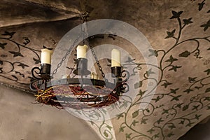 Period light fitting in A basement reception area and dining room  in medieval 14th Century Jaunpils Castle, now a hotel
