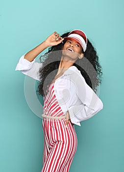 Jaunty cute young black woman wearing a red transparent hat