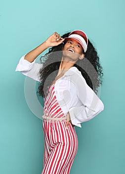 Jaunty cute young black woman wearing a red transparent hat photo