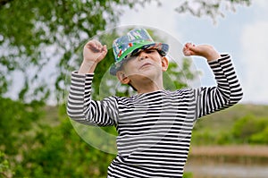 Jaunty macho little boy in a colorful trendy hat photo