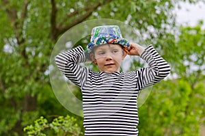 Jaunty macho little boy in a colorful trendy hat photo