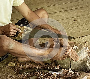 Java, Indonesia, June 13, 2022 - Man carves Tau Tau which are wooden effigies carved in Toraja to represent people who