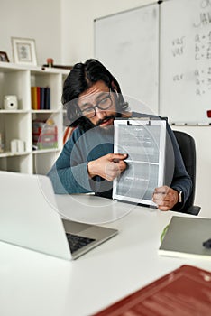 Java language online. Young professional computer programming teacher giving lesson online, explaining java basics while photo