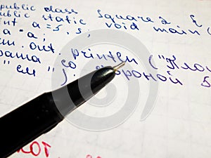 Java program in notepad and black pen. creation of computer programs. the work of the programmer and sisadmida