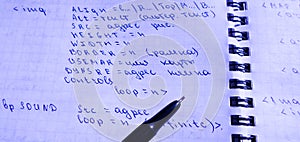 Translations of calculus systems on a notebook and black pen. creation of computer programs. work of the programmer and system