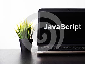 JavaScript programming language. Programming training, the concept of computer courses. Laptop on the table