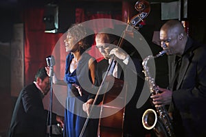 Jazz band performing in nightclub photo