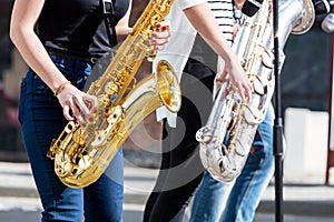 Jazz band of young musicians with saxophones performing during m