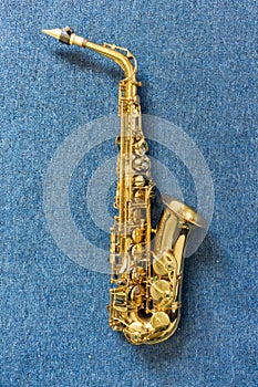 Jazz musician Golden saxophone on blue wall