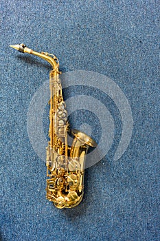 Jazz musician Golden saxophone on blue wall.