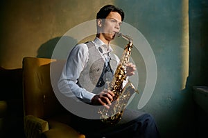 Jazz musician playing saxophone in front of window