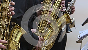 Jazz musicians play the saxophone, close-up.