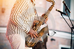 A jazzman performs at a concert with a melody played on a gold saxophone