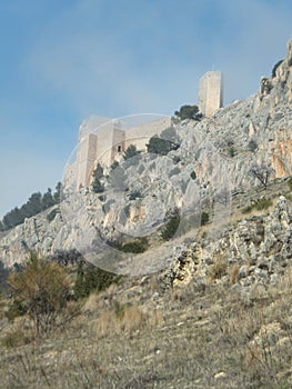 JaÃ©n castle in shreds of mist against blue sky