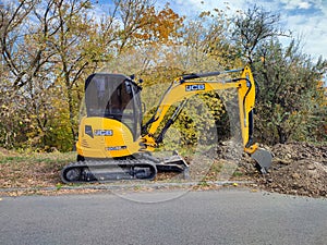 JCB digger or excavator performs excavation work outdoors