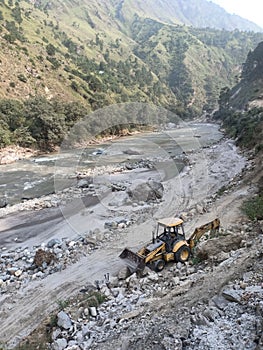 Jcb standing near river working