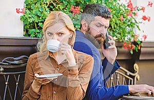 Jealous about lack of attention. First meet of girl and man. Morning coffee. Brutal bearded hipster and girl drink