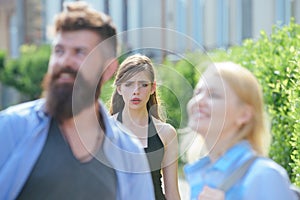 She is jealous. Unhappy girl feeling jealous. Bearded man cheating his girlfriend with another woman. Jealous woman look