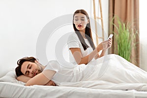 Jealous Wife Checking Husband& x27;s Phone While He Sleeping In Bedroom