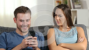 Jealous wife scolding her husband who is using phone