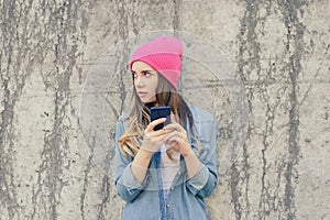 Jealous woman checking her boyfriend`s mobile phone. Woman reading secret sms on her mobile phone. She is dressed in casual cloth