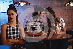 Jealous woman ignoring affectionate couple