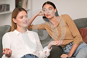 Jealous Woman Listening With Envy To Her Friend Bragging Indoors photo