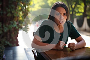 Jealous woman spying on ex boyfriend in outdoor cafe