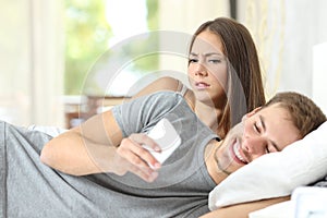 Jealous woman spying her husband mobile phone