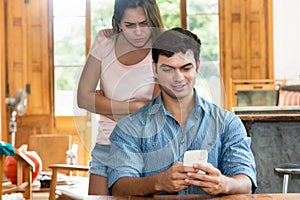 Jealousy woman checking chat on cellphone of boyfriend