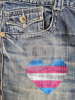 Jean with a transgender flag in a heart shape sewed in it