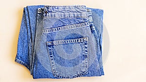 Jeans on the background, blue and black jeans lie on a white background,