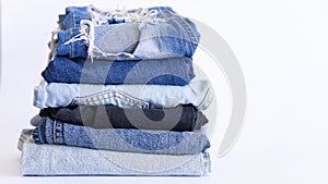 Jeans on the background, blue and black jeans lie on a white background,