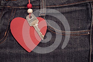 Jeans background with wooden heart and key..Valentine's day.