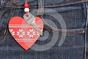 Jeans background with wooden heart and key..Valentine's day.