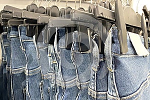 Jeans on hangers in a clothing store, close-up