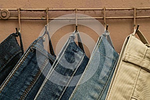 Jeans hanging on the back of a door