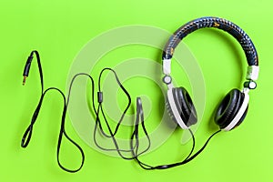 Jeans jacket headphone on green background, isolated