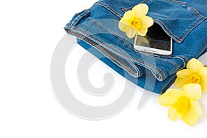 Jeans with Mobile Phone and Flowers on White Background