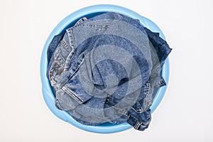 Jeans pants, denim in a bowl prepared for delicate hand washing, laundry concept