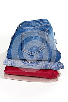 Jeans and pants folded on the stack.
