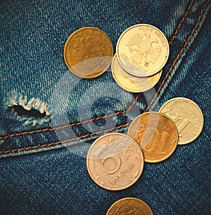 Jeans pocket with hole and coins