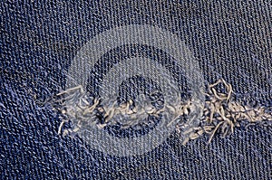 Jeans texture or background denim blue with tear