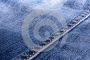Jeans texture. Denim. The seam on the fabric. light industry. Street youth fashion style
