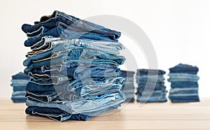 Jeans trousers stack on white background.