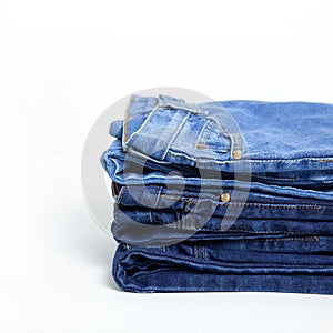 Jeans trousers stack on white background