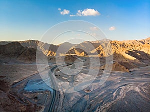 Jebel Jais mountain desert road surrounded by sandstones in Ras al Khaimah aerial view