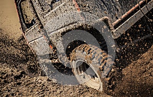 Jeep car splashing in muddy terrain