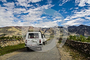 Jeep Caravan cars on road with View of Zanskar