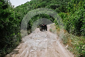 Jeep driving on a road in the mountains